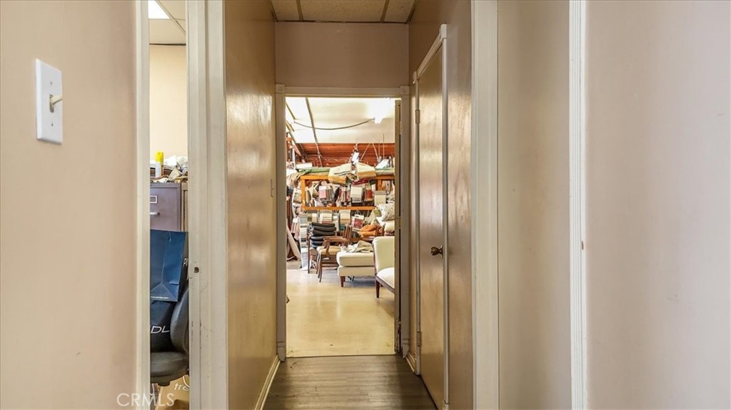 9706 Alondra Boulevard Bellflower, CA 90706 - Photo 12 of 24 a view of a hallway with a dining table and chairs