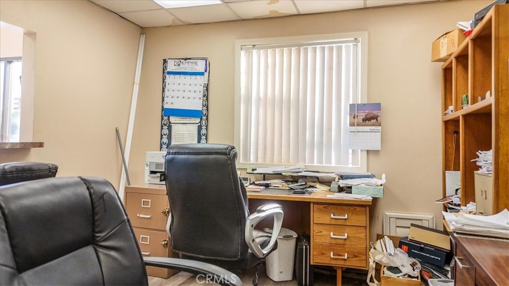 9706 Alondra Boulevard Bellflower, CA 90706 - Photo 13 of 24 a view of a workspace with furniture and a window