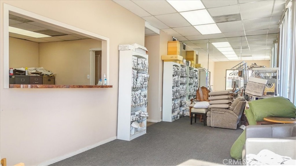 9706 Alondra Boulevard Bellflower, CA 90706 - Photo 8 of 24 a living room with furniture and a chandelier