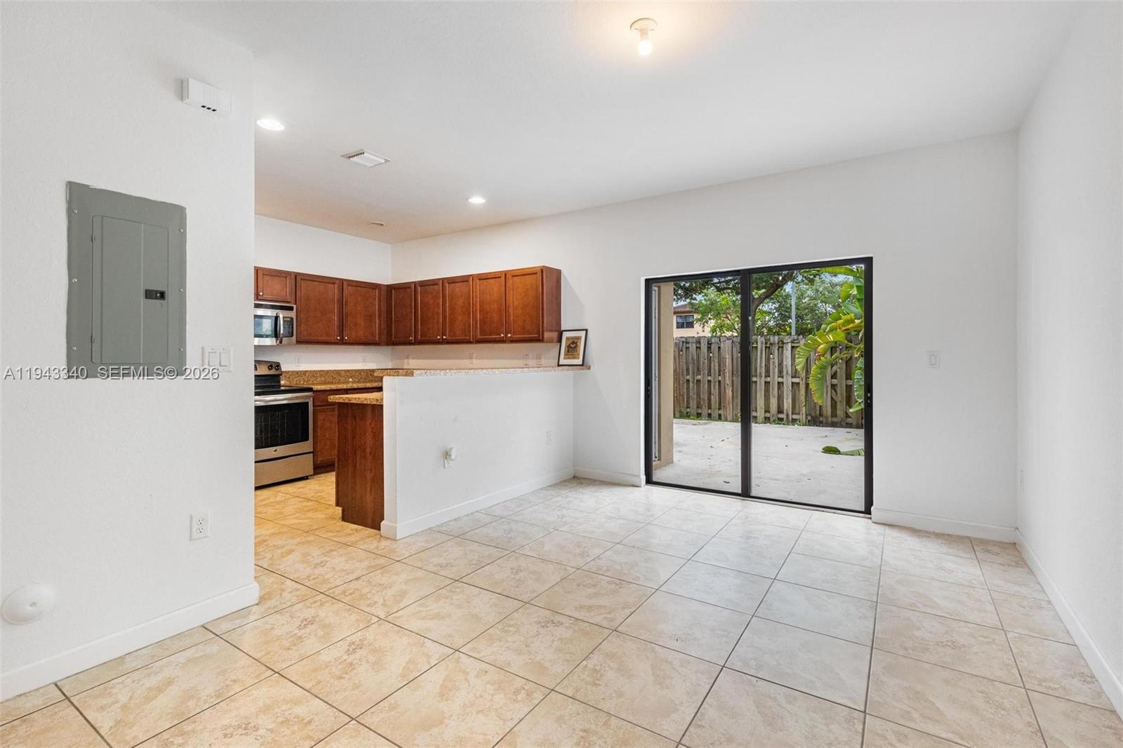 749 Southeast 32nd Terrace, Unit 749 Homestead, FL 33033 - Photo 19 of 27 a view of kitchen with stainless steel appliances granite countertop a stove top oven a sink and a refrigerator