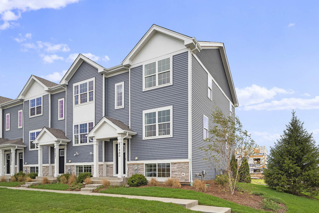 2241 Sassafras Way, Unit F Wonder Lake, IL 60097 - Photo 1 of 46 a front view of a house with a yard