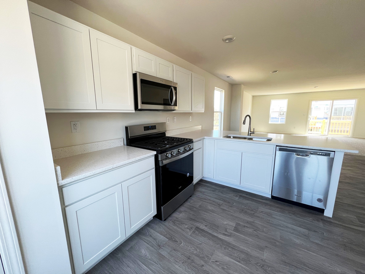 2241 Sassafras Way, Unit F Wonder Lake, IL 60097 - Photo 5 of 46 a kitchen with a sink and a stove top oven