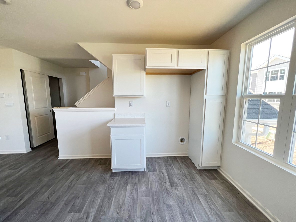 2241 Sassafras Way, Unit F Wonder Lake, IL 60097 - Photo 6 of 46 a view of an empty room with wooden floor and a window