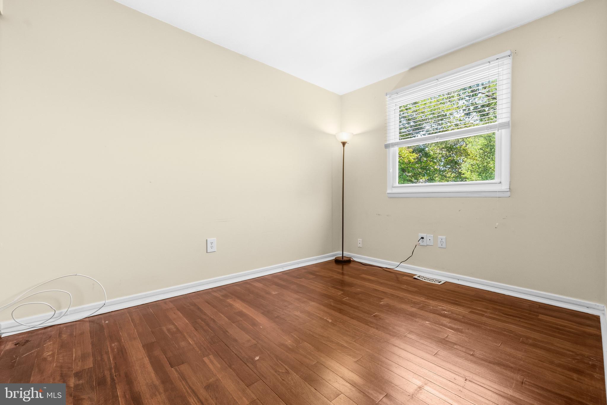 236 Inlet Drive Pasadena, MD 21122 - Photo 16 of 33 an empty room with wooden floor and windows