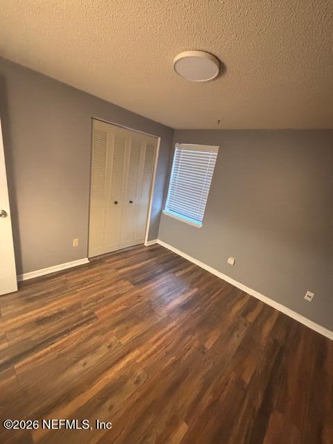 6626 Arrowroot Drive Jacksonville, FL 32244 - Photo 13 of 23 an empty room with wooden floor and windows