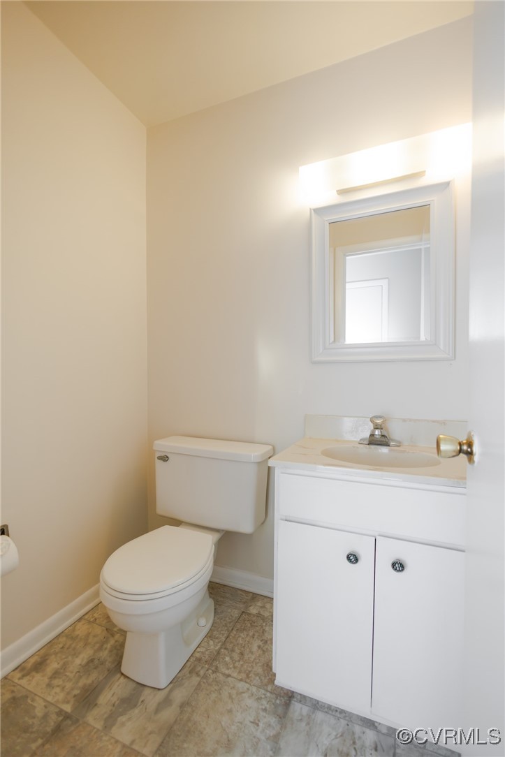 11808 North Briar Patch Drive Midlothian, VA 23113 - Photo 9 of 42 a bathroom with a toilet a sink a vanity and mirror