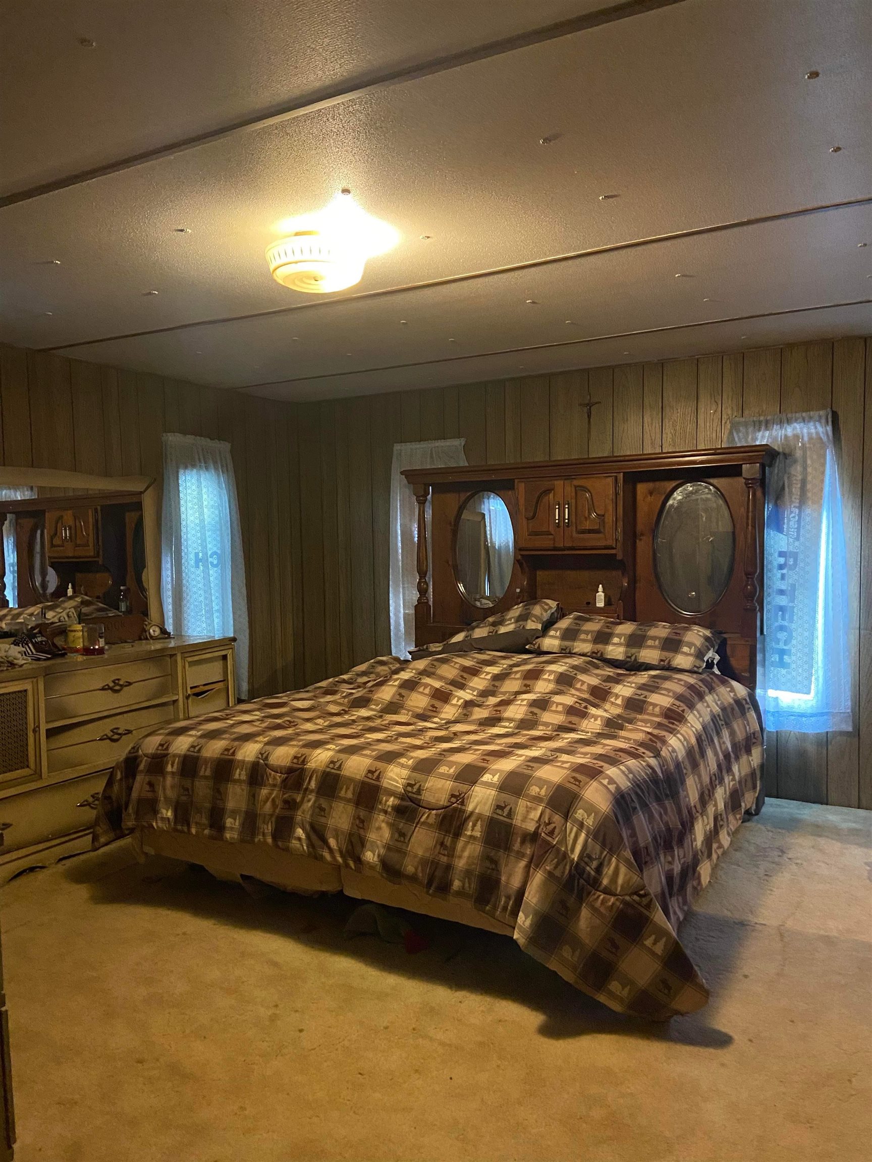 710 S Road Mack, CO 81525 - Photo 5 of 9 a large bed sitting in a bedroom next to a lamp