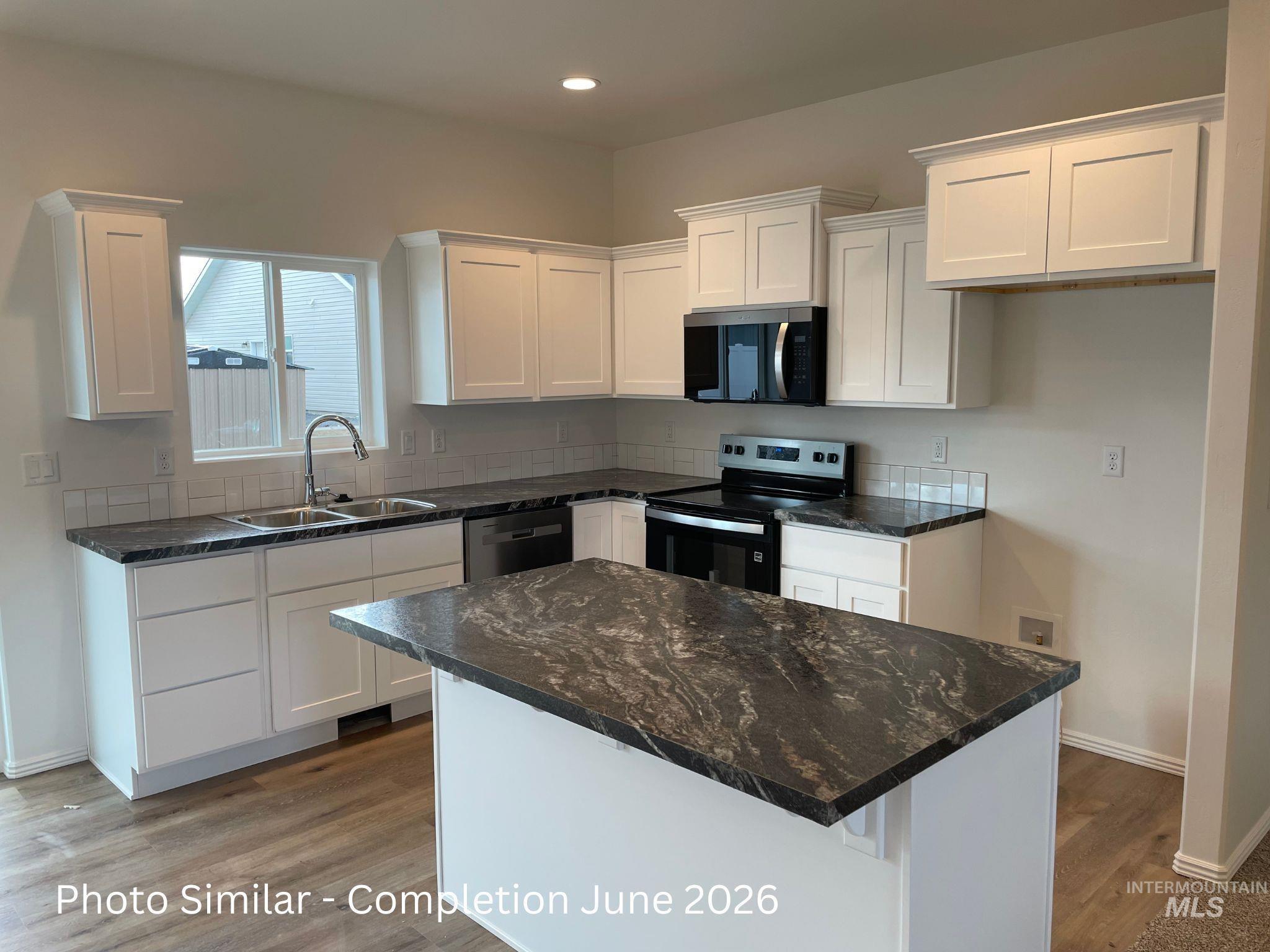 1329 Luther Road Jerome, ID 83338 - Photo 2 of 2 Kitchen featuring a kitchen island, stainless steel appliances, white cabinetry, dark stone countertops, and recessed lighting