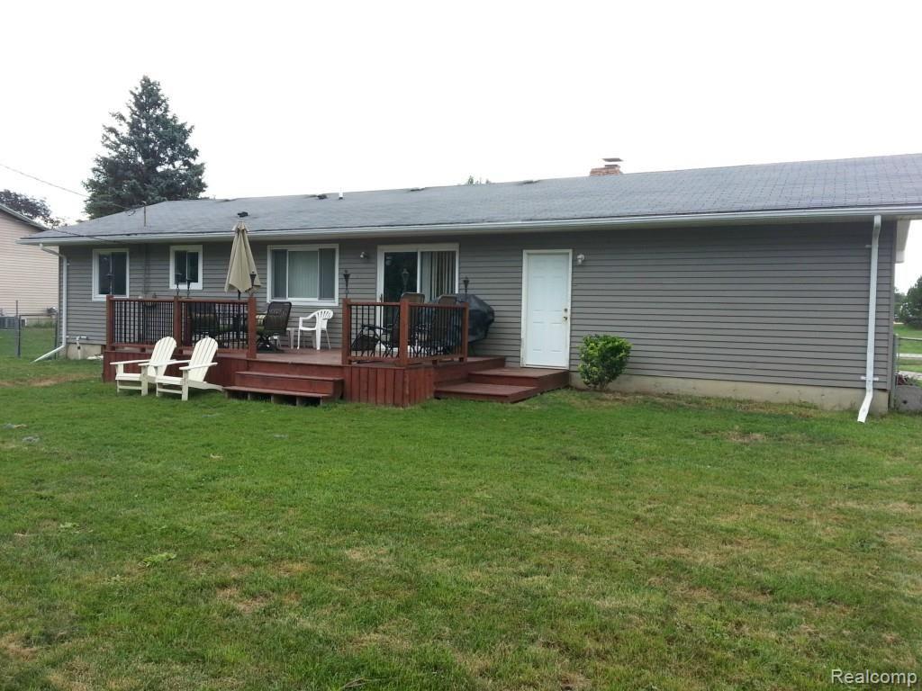 5221 North Fowlerville Road Fowlerville, MI 48836 - Photo 13 of 13 Back deck/yard