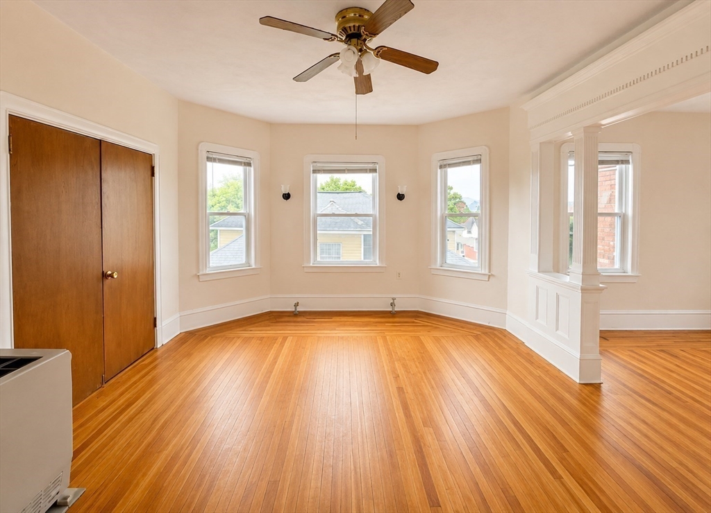 37 Shawmut Street Fall River, MA 02720 - Photo 2 of 16 a view of an empty room with wooden floor and a window