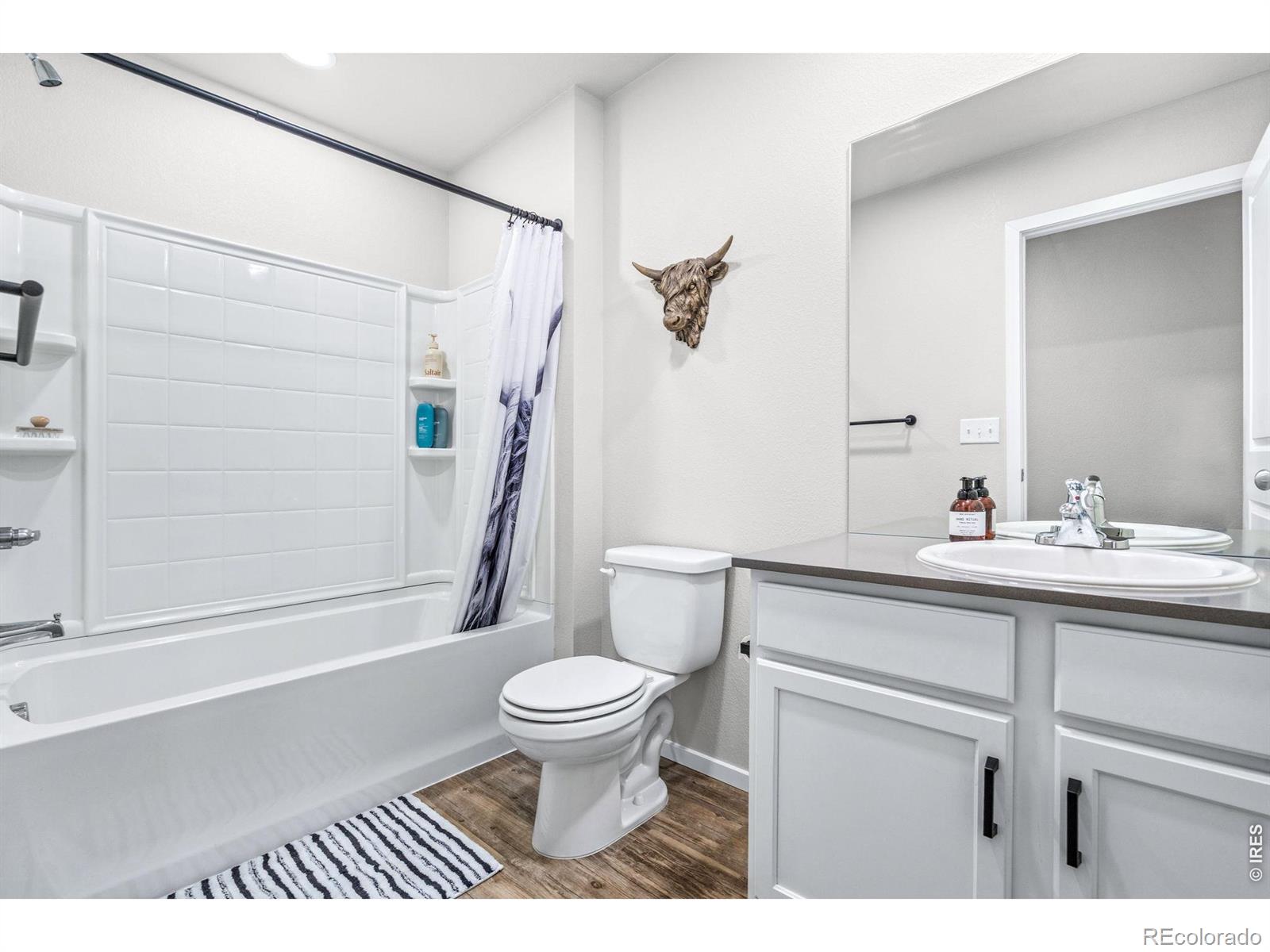6609 West 4th Street Road Greeley, CO 80634 - Photo 13 of 23 a bathroom with a sink a toilet and shower