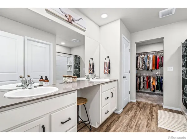 a spacious bathroom with a sink double vanity and a mirror