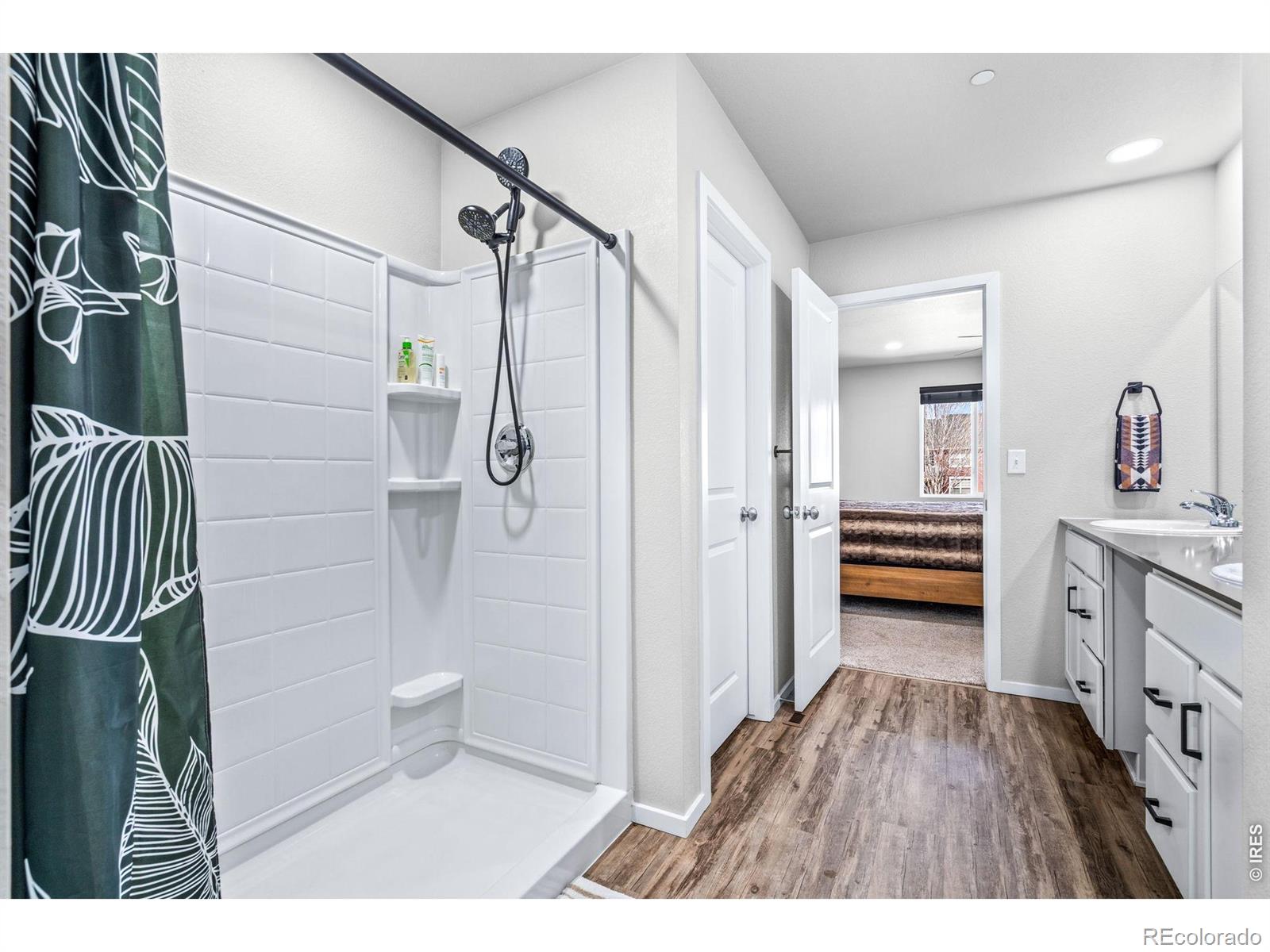 6609 West 4th Street Road Greeley, CO 80634 - Photo 15 of 23 a bathroom with a double vanity sink and mirror