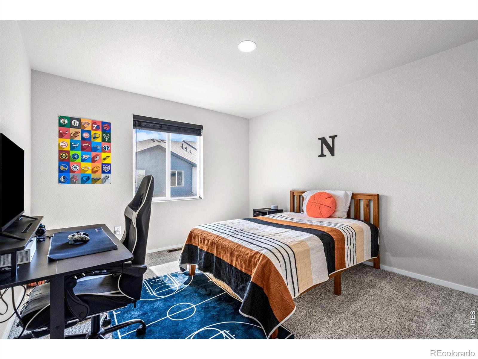 6609 West 4th Street Road Greeley, CO 80634 - Photo 17 of 23 a bedroom with a bed table chair and a desk