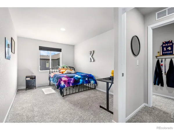 a bedroom with furniture and a window