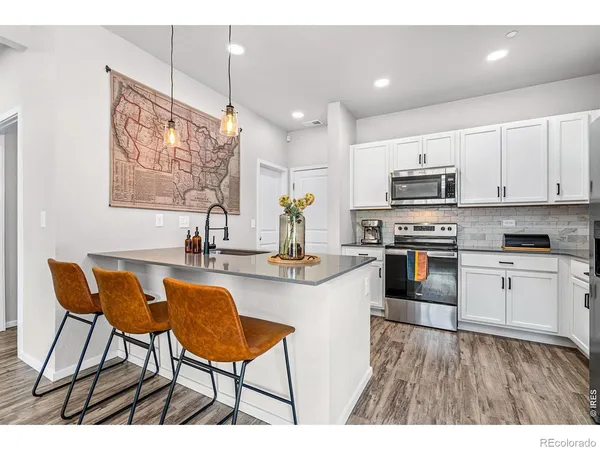 a kitchen with stainless steel appliances kitchen island granite countertop a sink and cabinets