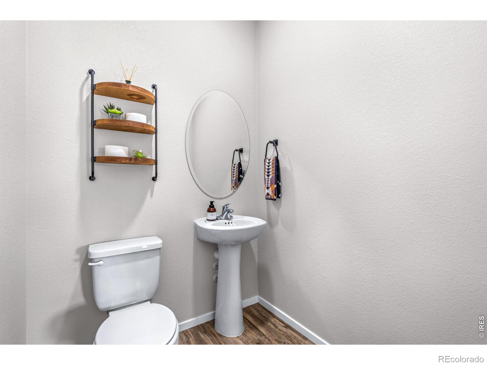 6609 West 4th Street Road Greeley, CO 80634 - Photo 9 of 23 a bathroom with a toilet sink and mirror