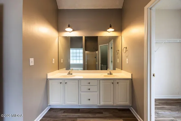 a spacious bathroom with double sink and a mirror