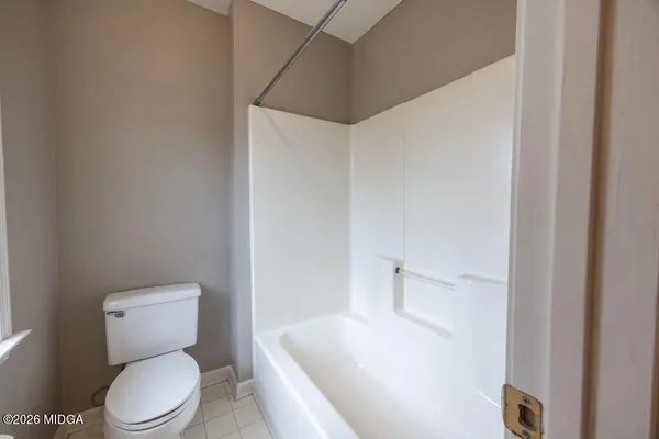 a white toilet sitting next to a bathroom sink