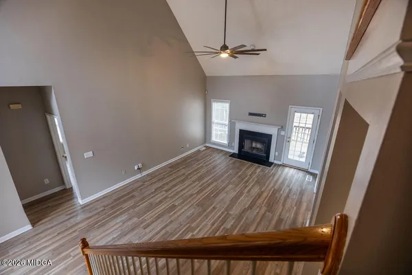 wooden floor in an empty room with a fireplace