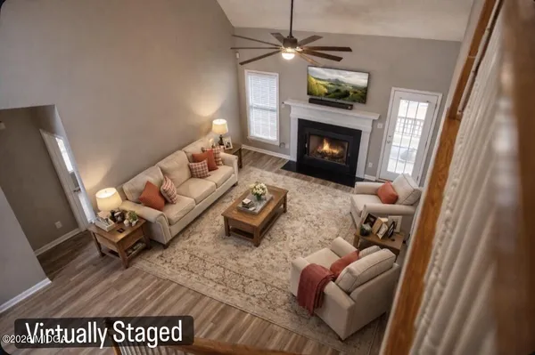 a living room with furniture and a fireplace