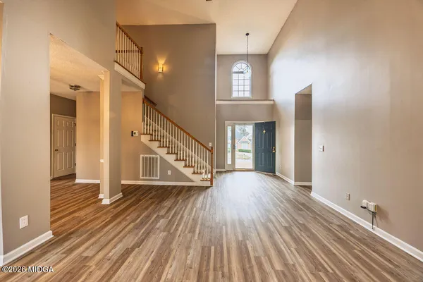 a view of an entryway with wooden floor