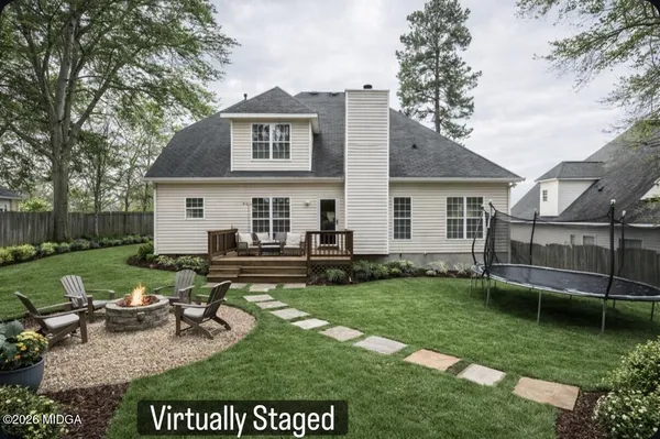 a view of a house with backyard sitting area and garden