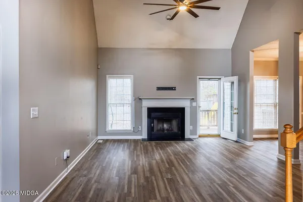 a view of an empty room with a fireplace and a window