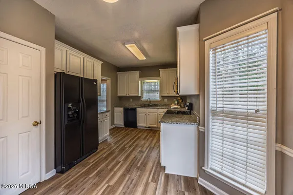 a kitchen with a refrigerator and a stove