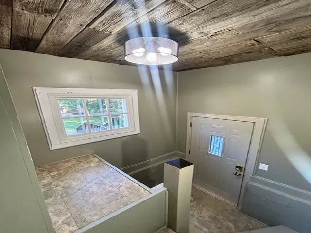 a view of a backyard and floor to ceiling window