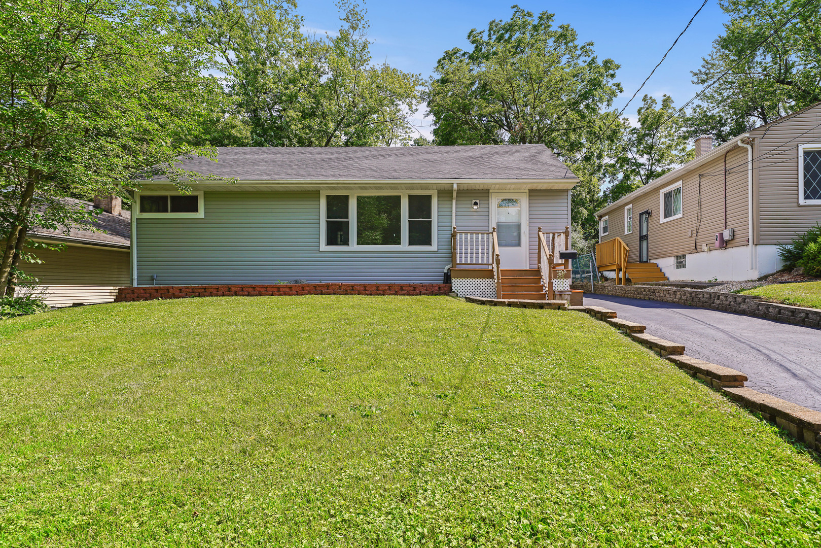 a view of a house with a backyard and a patio