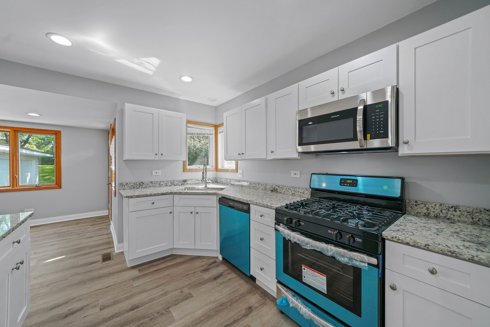1441 Burr Oak Road Homewood, IL 60430 - Photo 2 of 27 a kitchen with granite countertop a stove top oven sink and cabinets