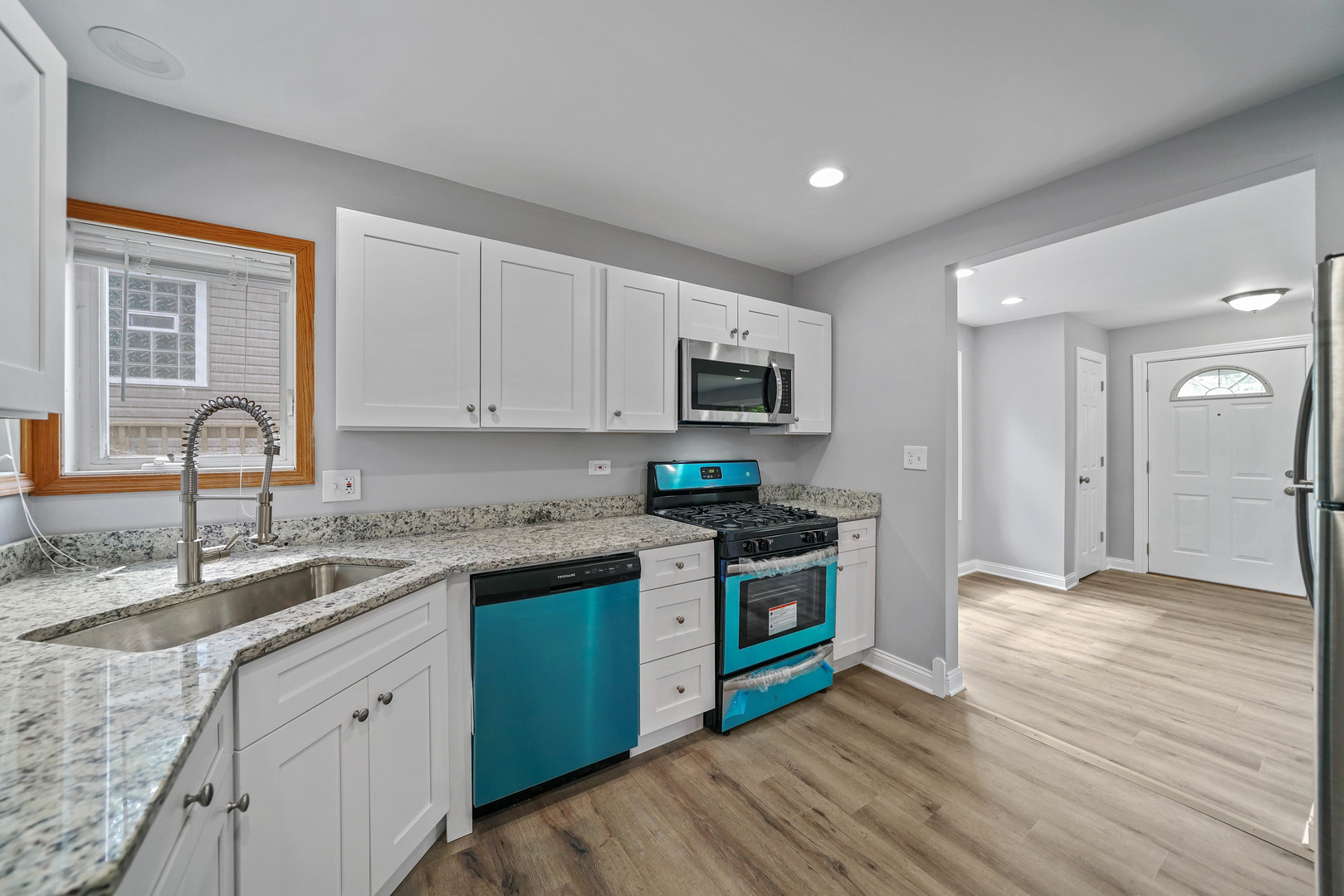 1441 Burr Oak Road Homewood, IL 60430 - Photo 4 of 27 a kitchen with stainless steel appliances granite countertop wooden cabinets a sink a stove a refrigerator and dishwasher with wooden floor