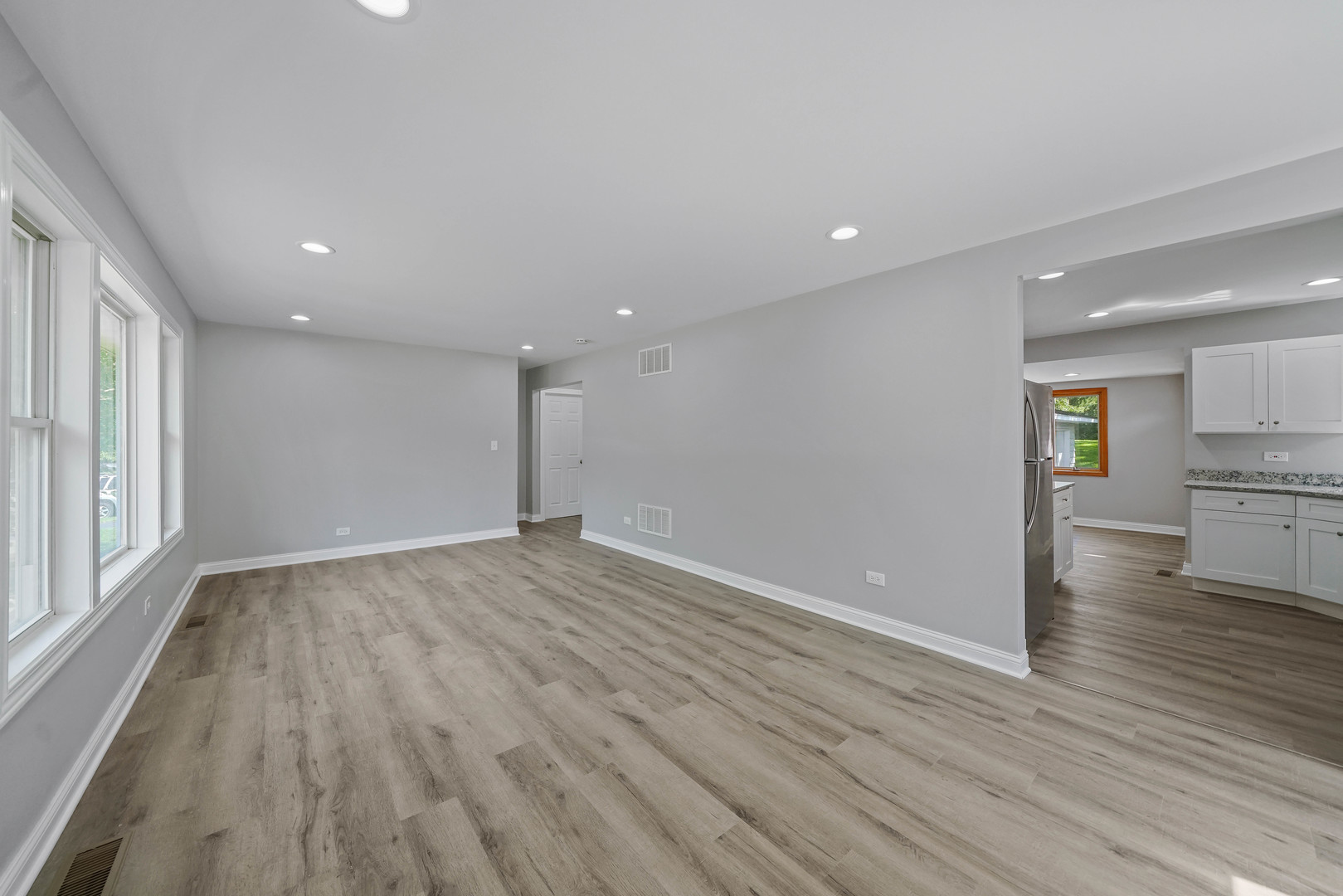 1441 Burr Oak Road Homewood, IL 60430 - Photo 6 of 27 a view of empty room with wooden floor and kitchen