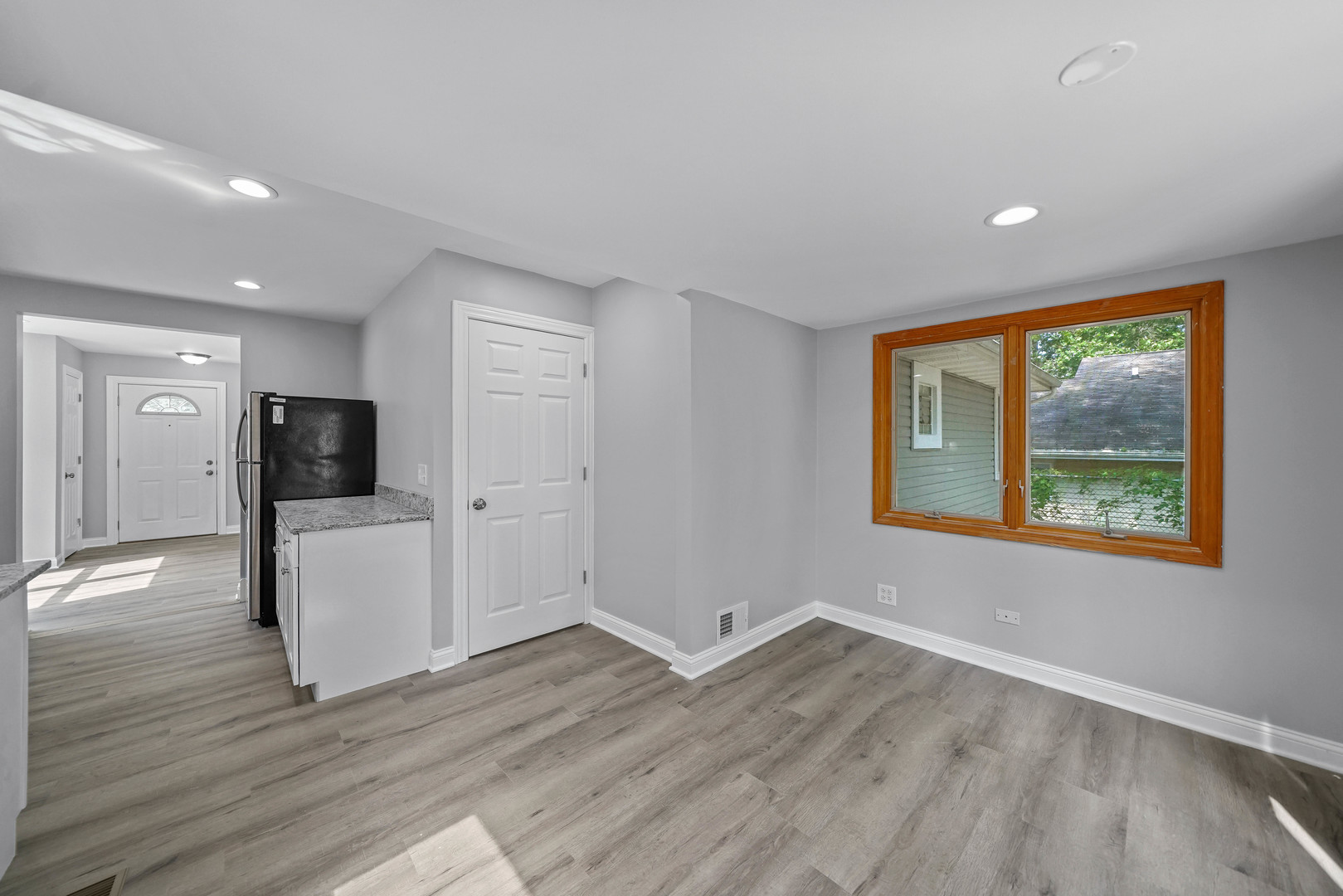 1441 Burr Oak Road Homewood, IL 60430 - Photo 9 of 27 an empty room with wooden floor and windows