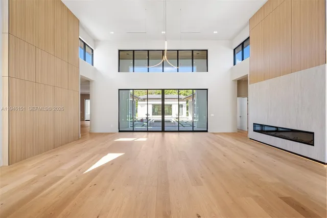a large kitchen with kitchen island a sink stainless steel appliances and cabinets