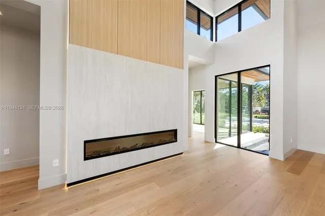 a kitchen with stainless steel appliances granite countertop a sink a stove and a wooden floors