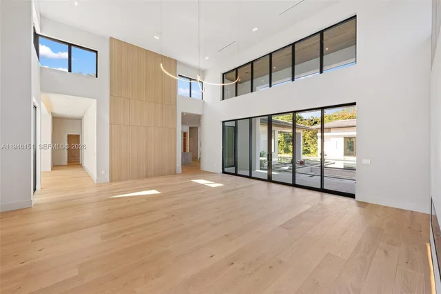 a kitchen with kitchen island stainless steel appliances a sink a stove and a wooden floors