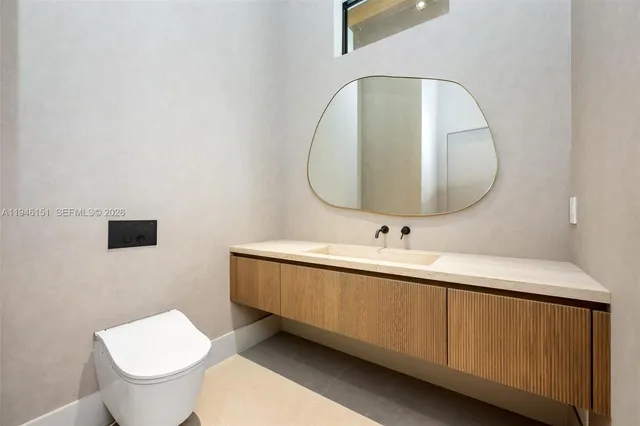 a bathroom with a sink and a large mirror