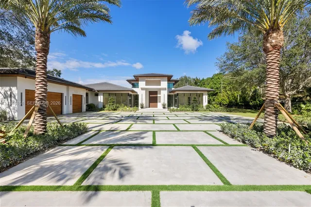a front view of house with yard and green space