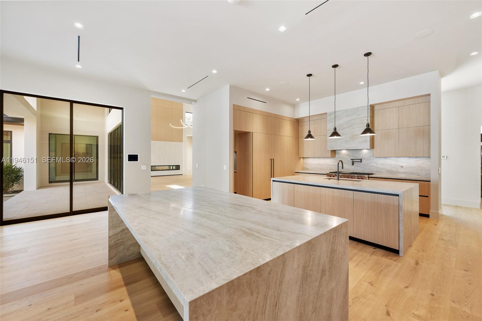 7725 Southwest 114th Street Pinecrest, FL 33156 - Photo 24 of 94 a large kitchen with kitchen island a sink stainless steel appliances and cabinets