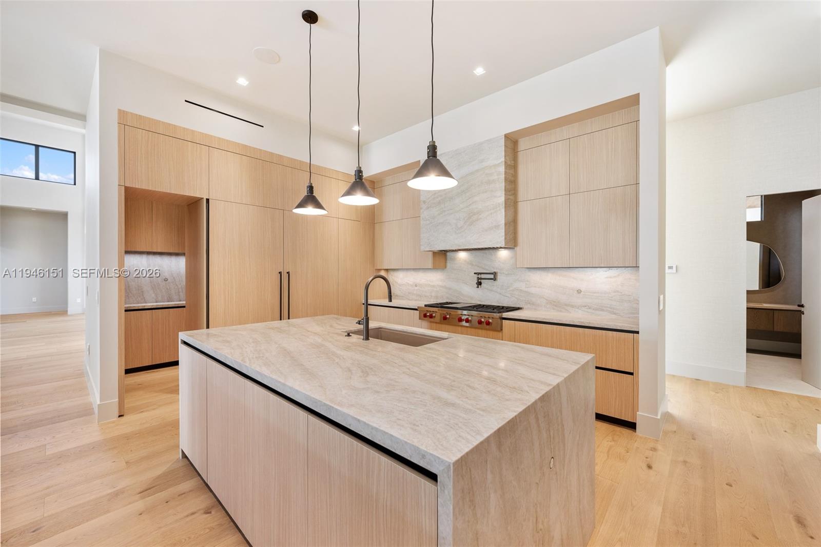 7725 Southwest 114th Street Pinecrest, FL 33156 - Photo 31 of 94 a kitchen with a stove a counter space a sink and cabinets