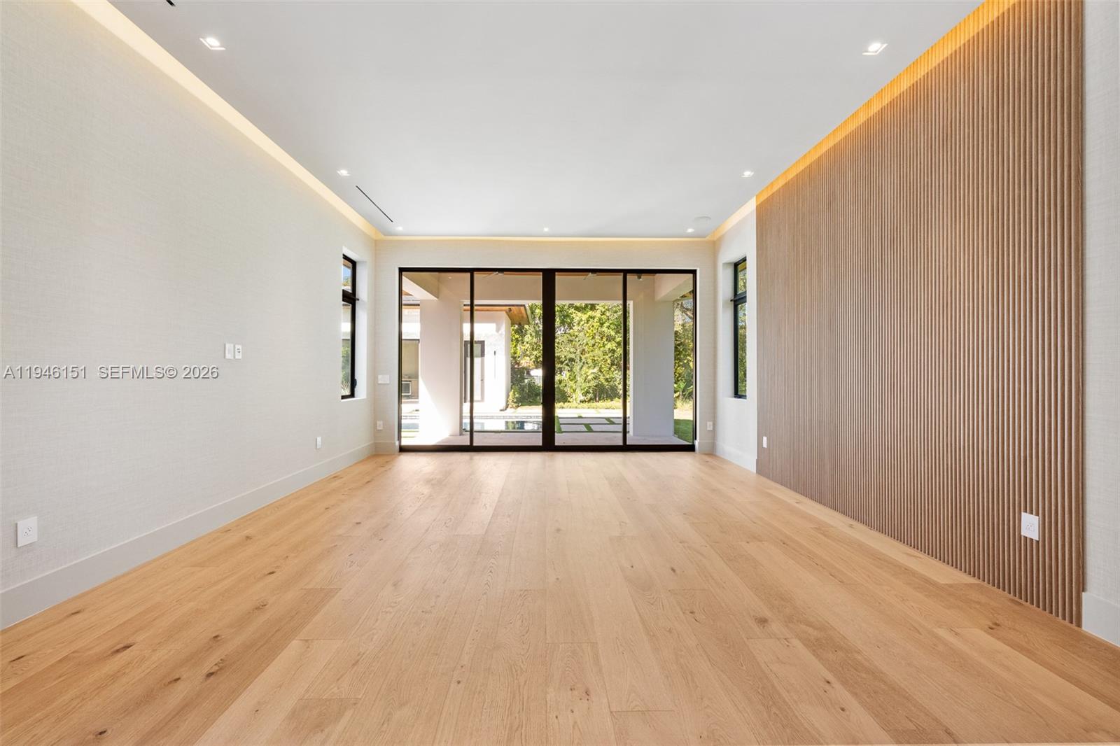 7725 Southwest 114th Street Pinecrest, FL 33156 - Photo 50 of 94 wooden floor in an empty room with a window
