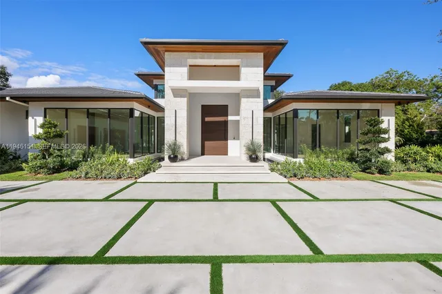 a view of an empty room with glass door and a window