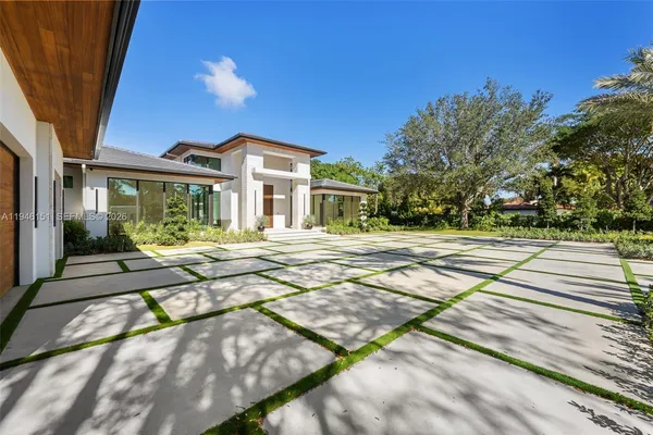 a view of an empty room with glass door and a window
