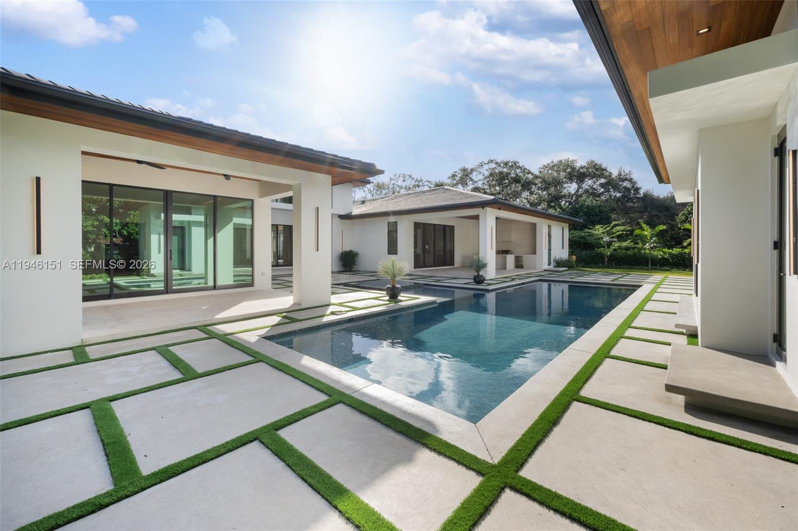 7725 Southwest 114th Street Pinecrest, FL 33156 - Photo 81 of 94 a view of a patio with swimming pool table and chairs