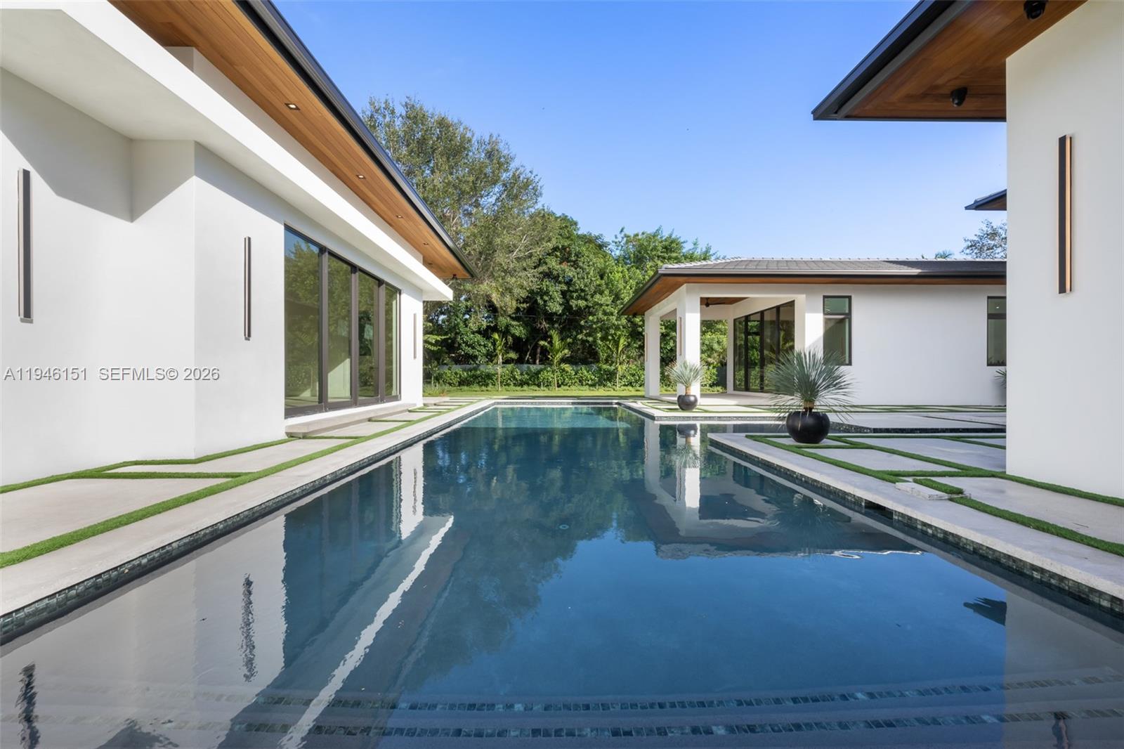 7725 Southwest 114th Street Pinecrest, FL 33156 - Photo 84 of 94 a view of a swimming pool with a porch