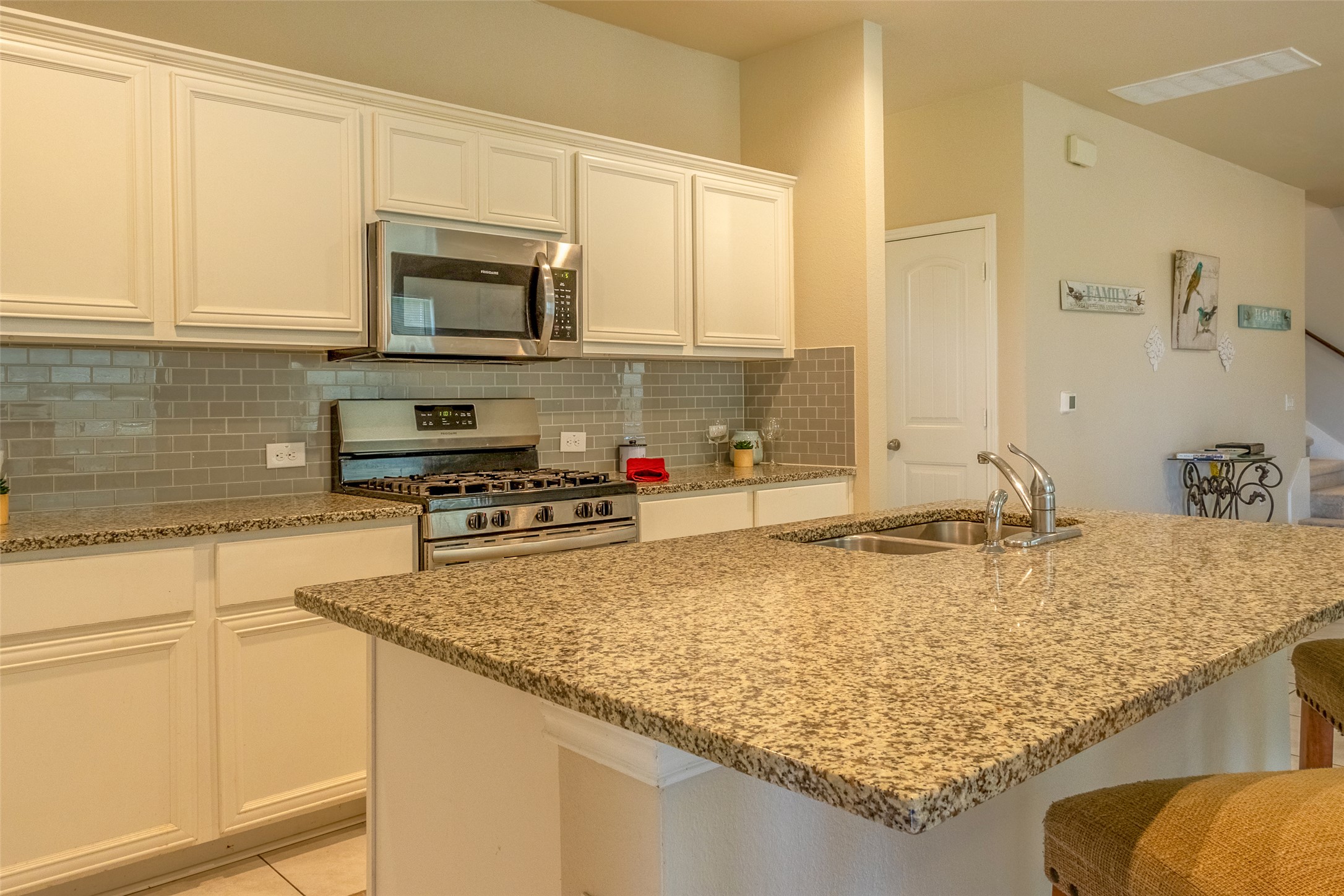 7225 Ranchito Drive Austin, TX 78744 - Photo 4 of 39 Culinary delights await in this spacious kitchen featuring granite countertops and stainless steel appliances.