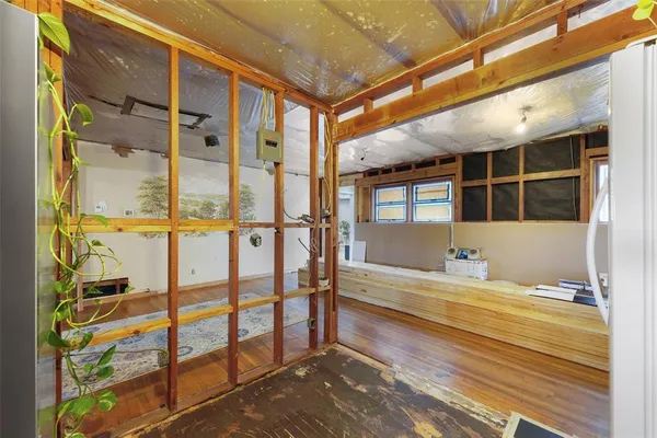 a view of a hallway with wooden walls