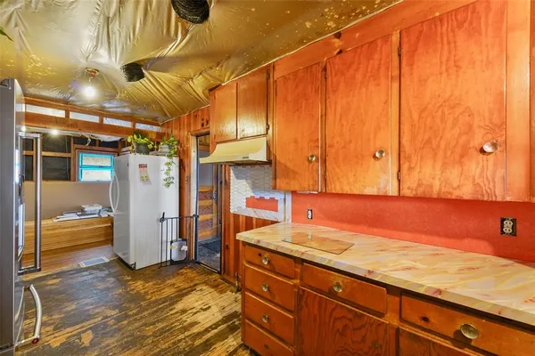 a spacious bedroom with a bed and a wooden floor